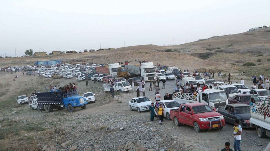 Dohuk 2014-08-04 DOHUK, IRAQ - AUGUST 4 : Thousands of Iraqis flee from the town of Sinjar, near the city of Mosul, to Erbil and Dohuk after armed groups affiliated with the Islamic State of Iraq and the Levant (ISIL) seized the town early on August 4, 2014. The violence in Iraq has escalated since early June after a coalition of armed insurgent groups led by ISIL - - or the Islamic State of Iraq and the Levant which had later changed its name to "Islamic State" - - took control of large swathes....