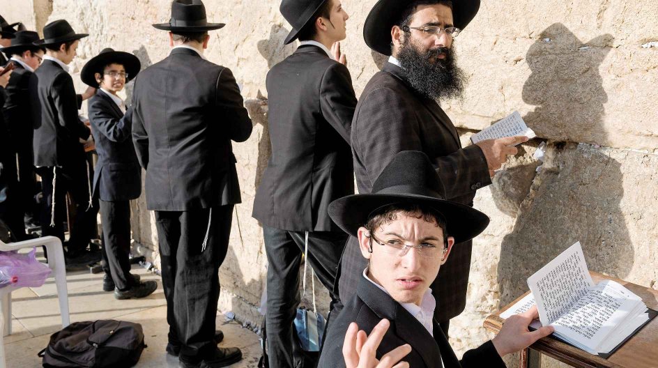 Jerusalem, Israel, May 28, 2014 Orthodox jews are praying at the Western Wall or Wailing Wall. This wall is a remnant of the ancient wall that surrounded the Jewish Temple's courtyard, and is arguably the most sacred site recognized by the Jewish faith.