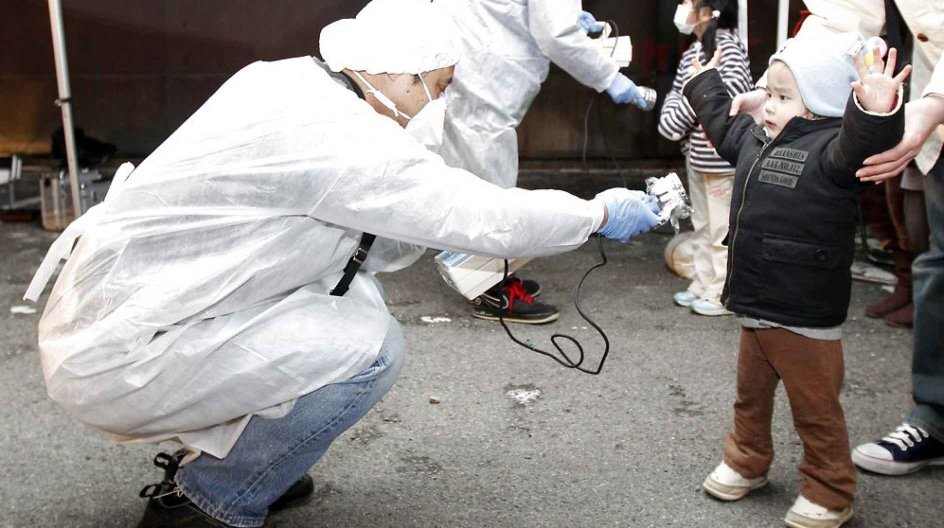 Officials in protective gear check for signs of radiation on children who are from the evacuation area near the Fukushima Daini nuclear plant in Koriyama in this March 13, 2011 file photo. The biggest earthquake to hit Japan on record struck the northeast coast, triggering a 10-metre tsunami that swept away everything in its path, including houses, ships, cars and farm buildings on fire and caused the meltdown of the Fukushima nuclear power plant. REUTERS/Kim Kyung-Hoon/Files (JAPAN - Tags: DISA....