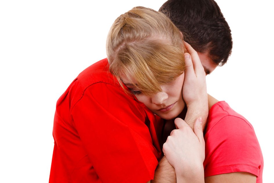 Couple hugging. Woman is sad and being consoled by his partner. Man comforting his girlfriend. Troubled girl and her boyfriend. Studio shot on white