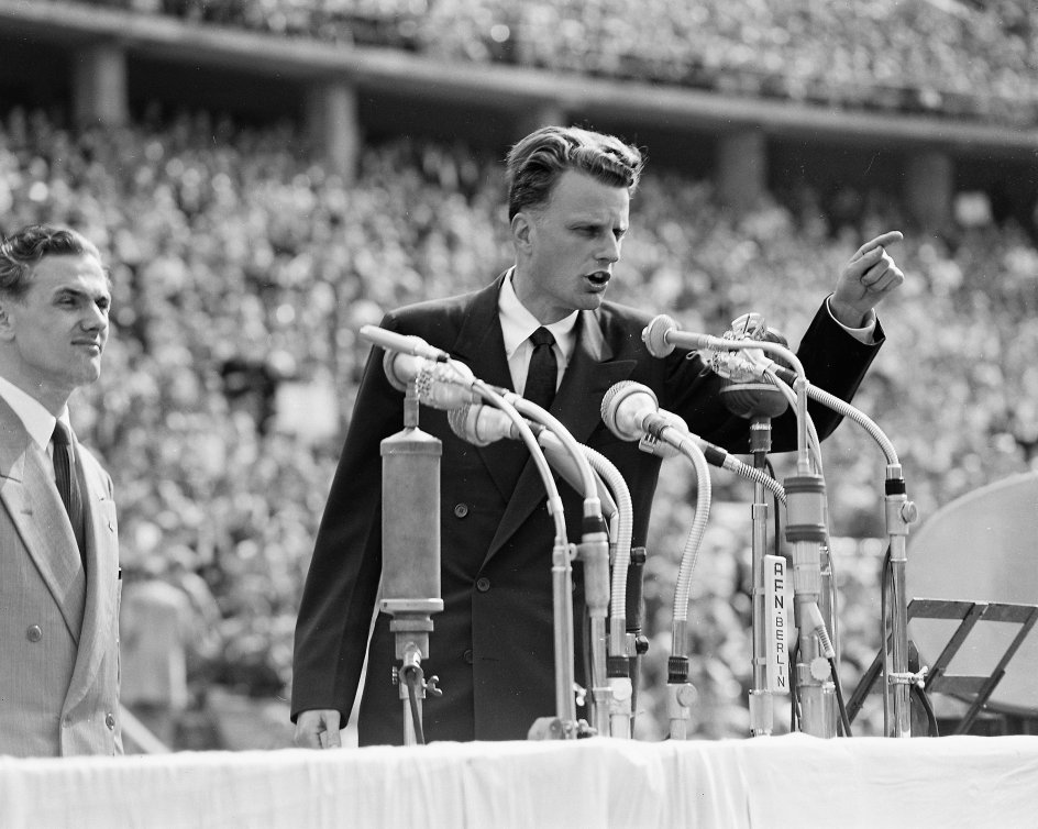 Billy Graham formåede at tryllebinde masserne med sine vækkelsesmøder som her på Berlins Olympiastadion under sin store Europa-turné i 1954. –