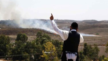"We are here to see Israel destroy Hamas," says Eli Chone, a 22-year-old American living in Israel. The picture shows an orthodox jew gesturing as a bomb fired from Gaza lands near the Israeli town of Sderot. Gaza's firings of bombs against Israel has in recent days led to massive Israeli air strikes on the Hamas-controlled territory.